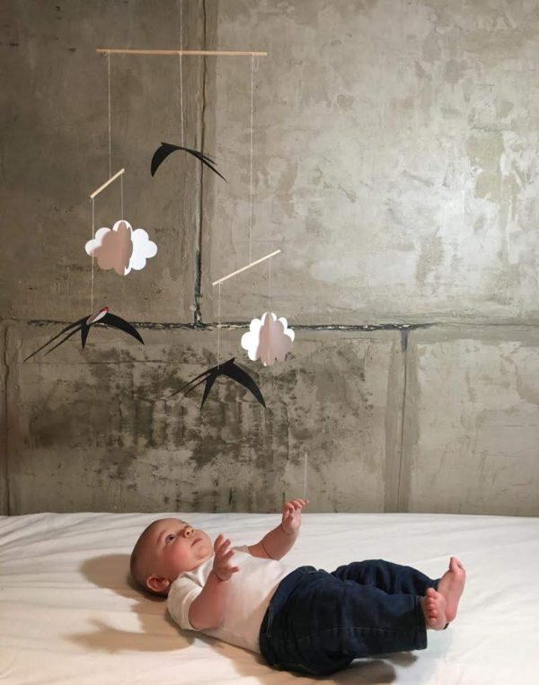 A baby with the DIY-Swallows-mobile