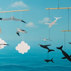 DIY Montessori-style nautical baby mobile featuring paper whales and seagulls, gently hanging for newborn visual development