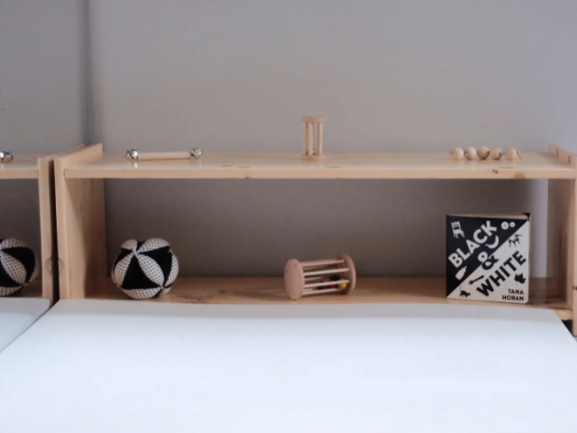 Montessori polcok, Montessori baby shelf with natural wooden toys, a black and white mobile, and soft ambient lighting in a peaceful nursery - are montessori toys worth it, ¿Valen la pena los juguetes Montessori para bebés? Una guía honesta por edades, Montessori pregnancy preparation